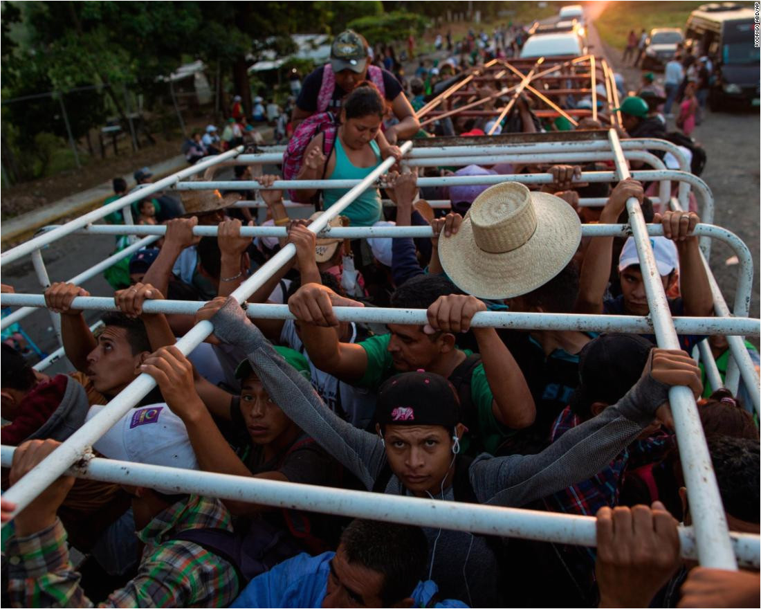 migrants travel on a cattle truck as a thousands strong caravan of central american