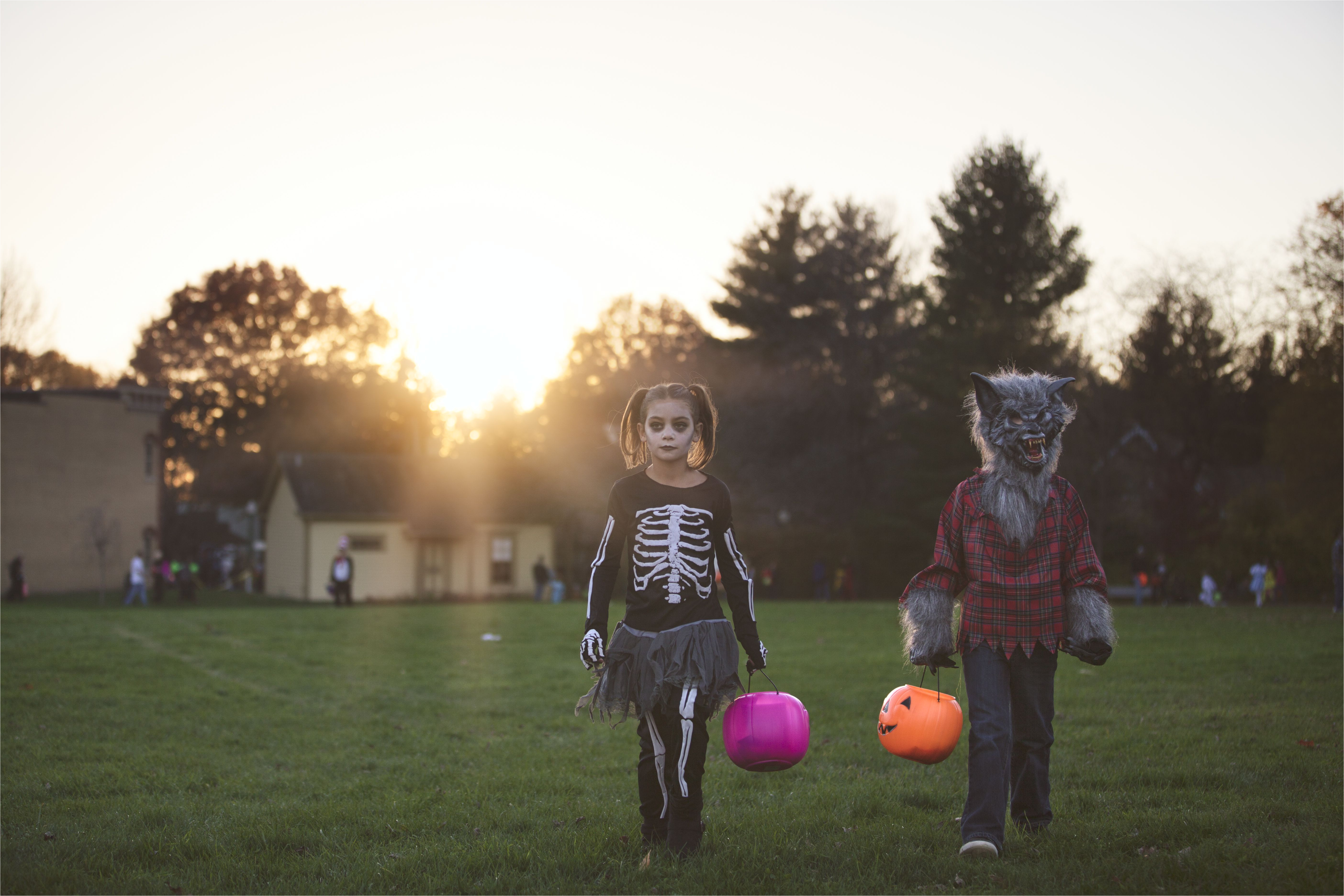 costumed children walking across grassy field 522825703 5a28c2b99e94270037c09613 jpg