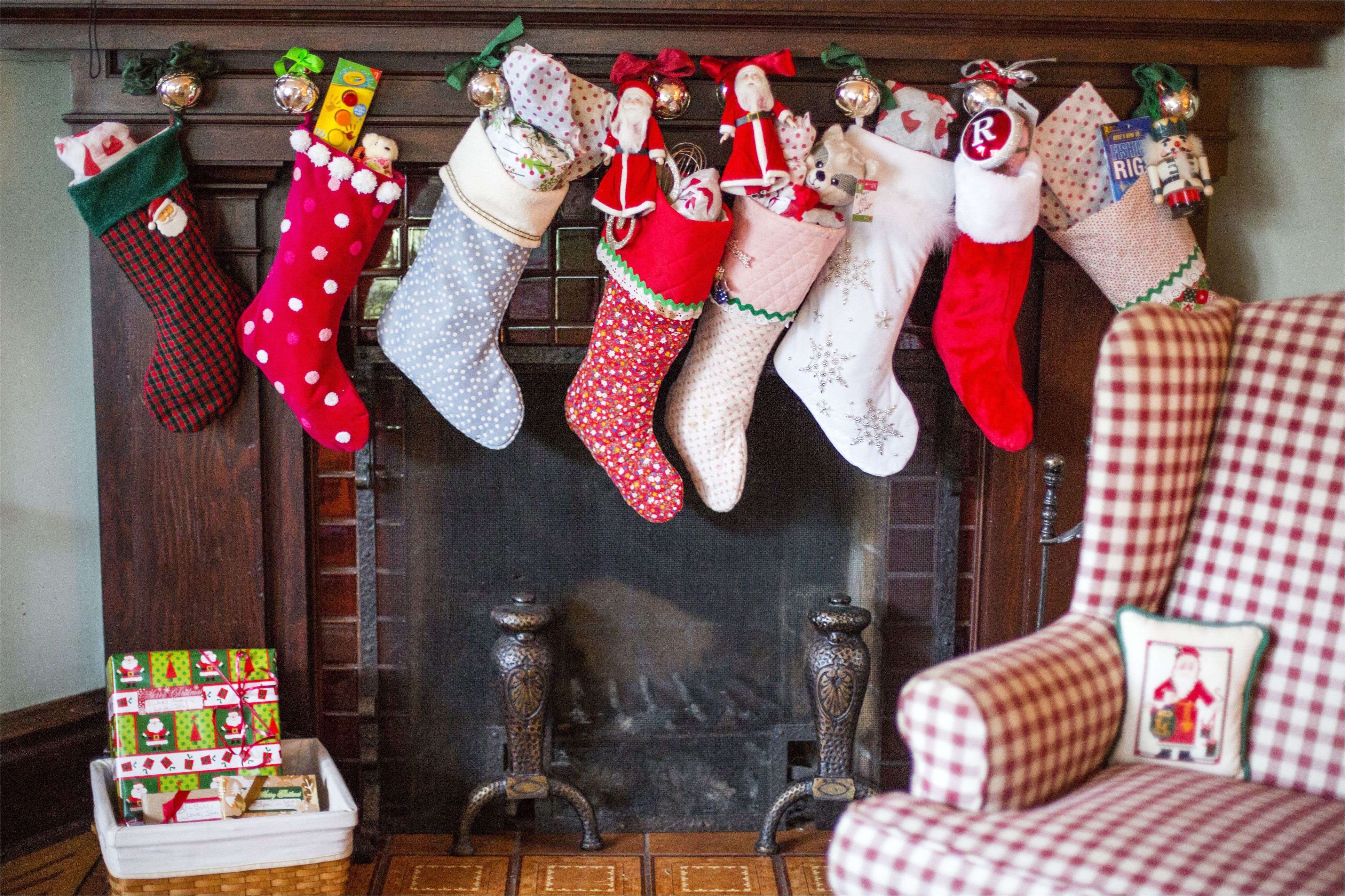 stuffed christmas stockings over fireplace 554370543 59f7502baf5d3a0010de738d jpg