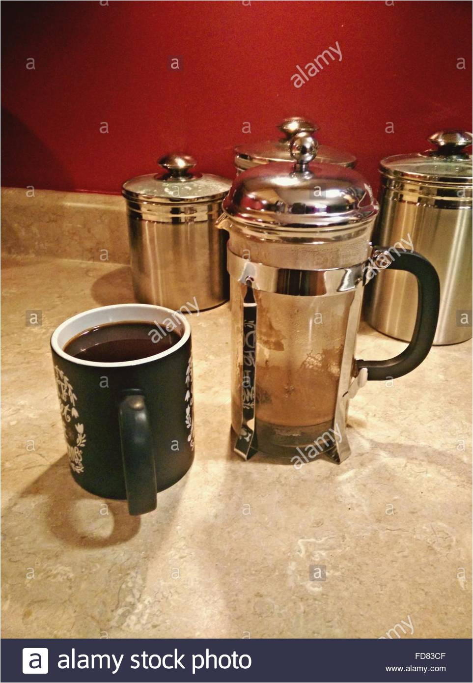 coffee mug and pot with jars on floor stock image