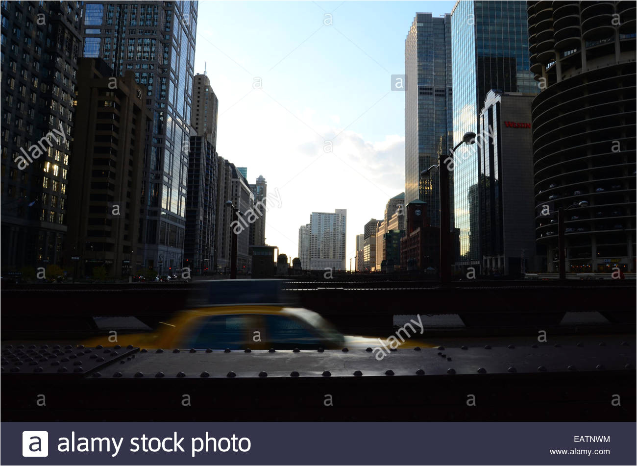 a yellow cab speeds across the north wabash avenue bridge stock image