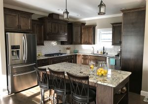 Alaska White Granite with Brown Cabinets Dark Walnut Stained Cabinets Alaska White Granite White Subway