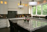 Alaska White Granite with Brown Cabinets Lennon Granite Completed with Gray Subway Tiles and Cupboard Back