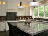 Alaska White Granite with Brown Cabinets Lennon Granite Completed with Gray Subway Tiles and Cupboard Back