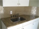 New Venetian Gold Granite Subway Tile Backsplash Example Of New Venetian Gold Granite In White Kitchen with