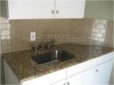 New Venetian Gold Granite with Subway Tile Backsplash Example Of New Venetian Gold Granite In White Kitchen with